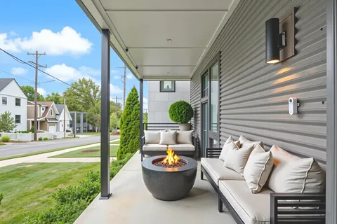 a front view of a house with patio and garden