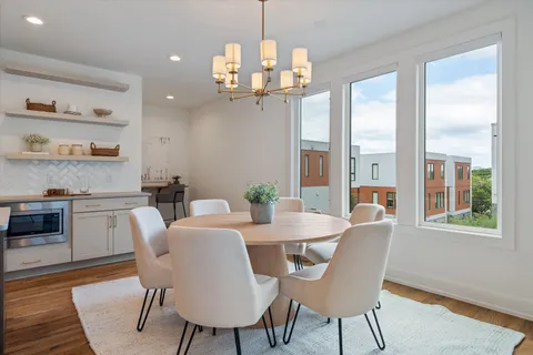 a view of a dining room with furniture large window and wooden floor