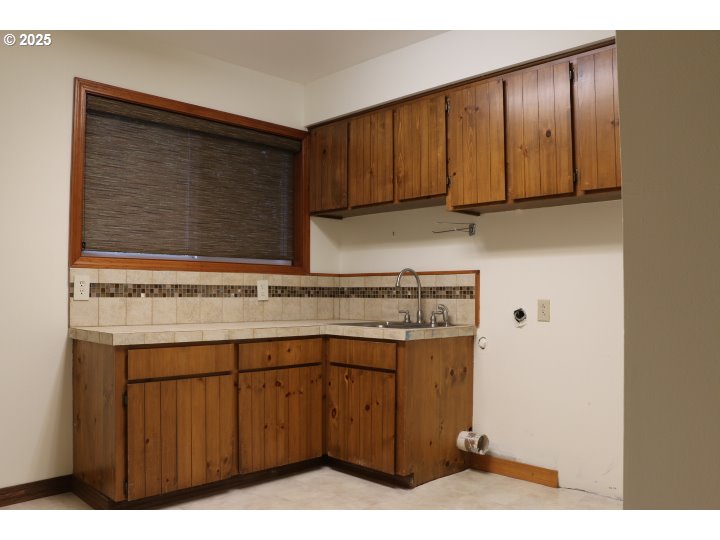 6503 Kinns Road Northeast Woodburn, OR 97071 - Photo 28 of 45 a kitchen with a sink cabinets and a microwave oven