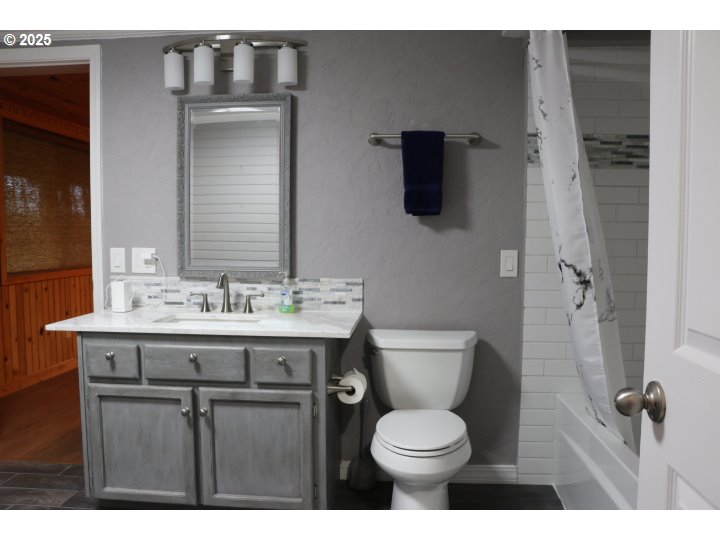 6503 Kinns Road Northeast Woodburn, OR 97071 - Photo 35 of 45 a bathroom with a granite countertop toilet sink and mirror