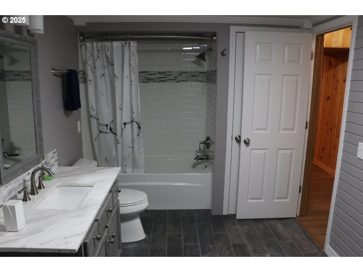 6503 Kinns Road Northeast Woodburn, OR 97071 - Photo 36 of 45 a bathroom with a granite countertop sink toilet and shower