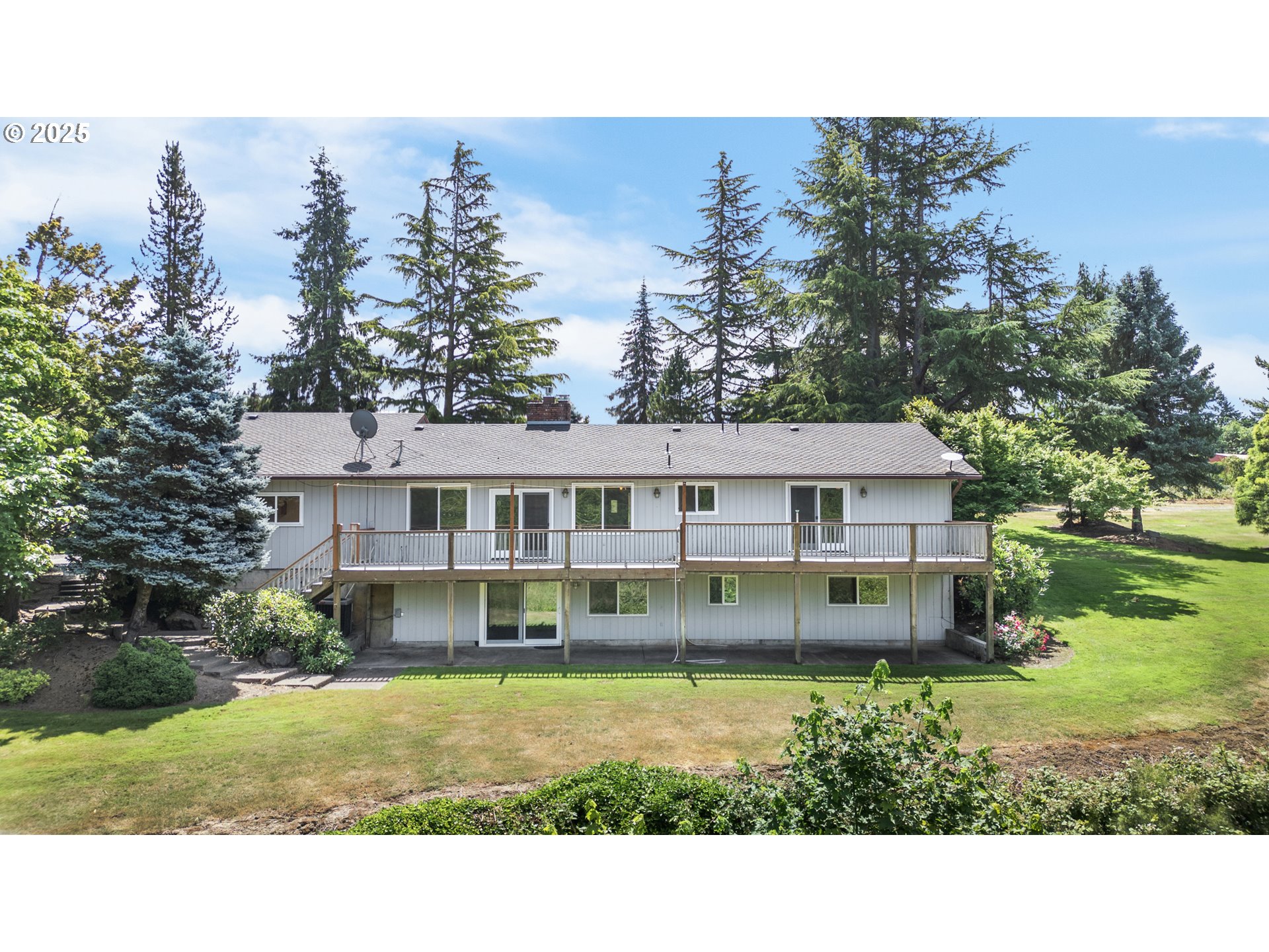 6503 Kinns Road Northeast Woodburn, OR 97071 - Photo 41 of 45 a view of a big house with a big yard and large trees