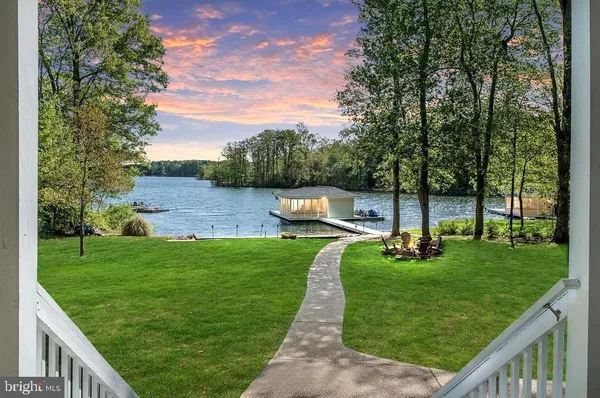 a view of a garden with a house in the background
