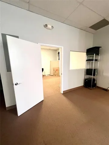 a view of empty room with furniture and refrigerator