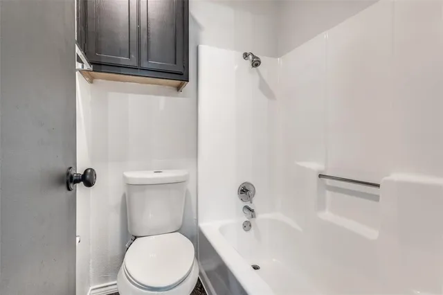 a white toilet sitting next to a bathroom sink
