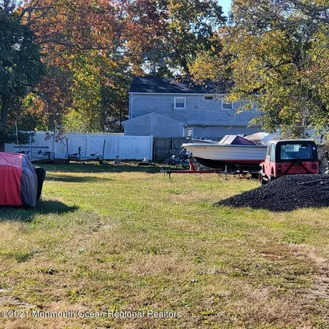 a view of a swimming pool with lawn chairs under an umbrella