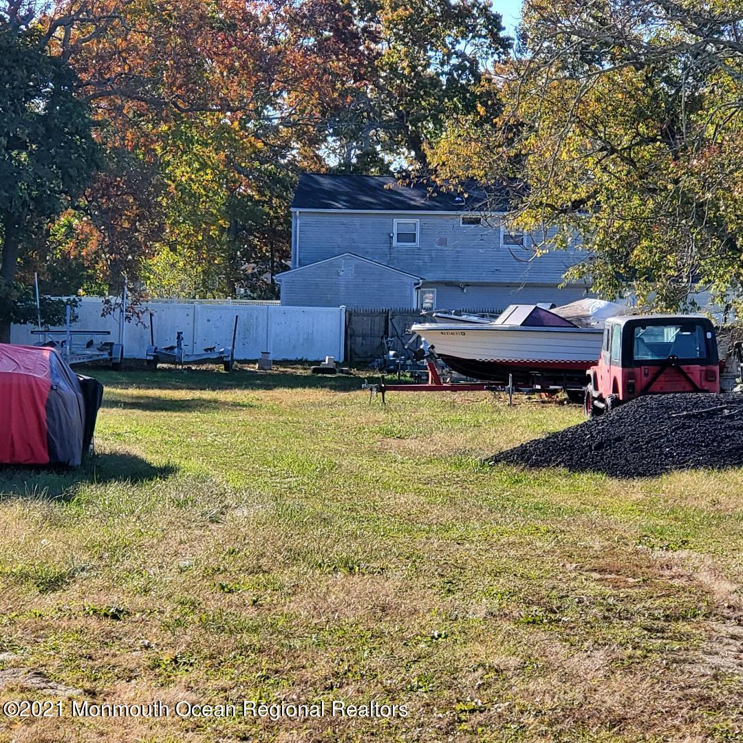 370 Highway 9 Little Egg Harbor, NJ 08087 - Photo 2 of 6 a view of a swimming pool with lawn chairs under an umbrella