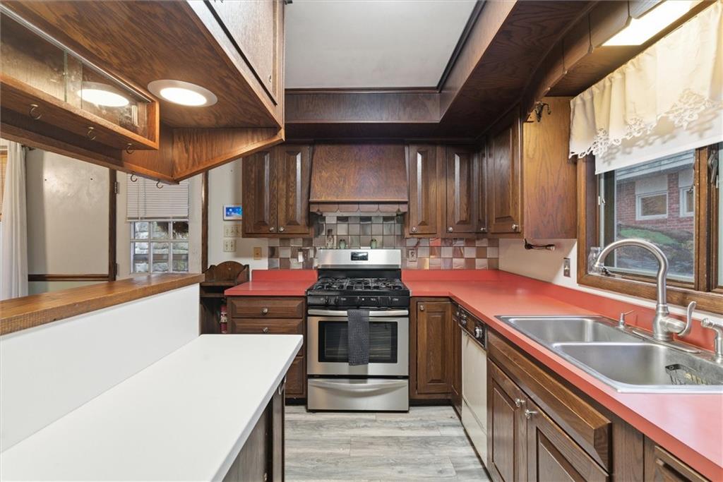 312 Flatwoods Road Vanderbilt, PA 15486 - Photo 5 of 48 a kitchen with stainless steel appliances granite countertop a sink stove and cabinets