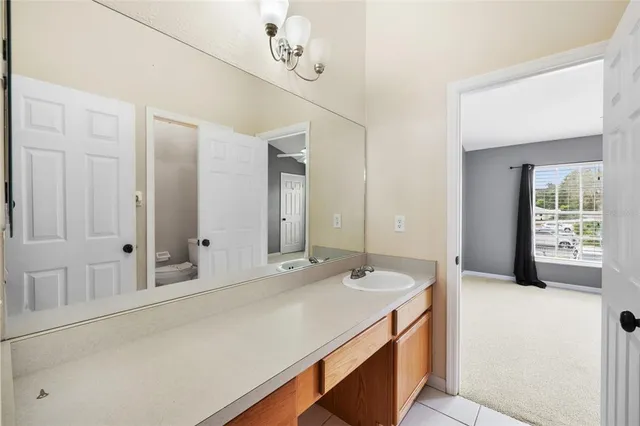 a spacious bathroom with a sink and a mirror