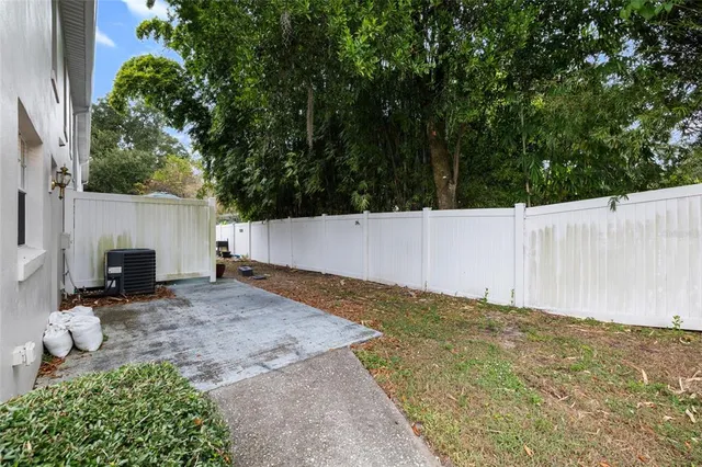 a backyard of a house with table and chairs