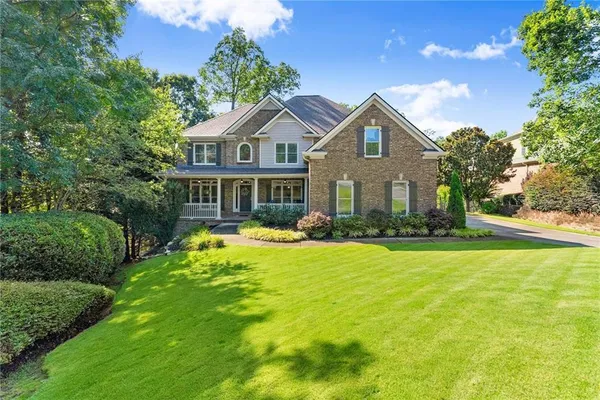 a front view of a house with swimming pool and porch