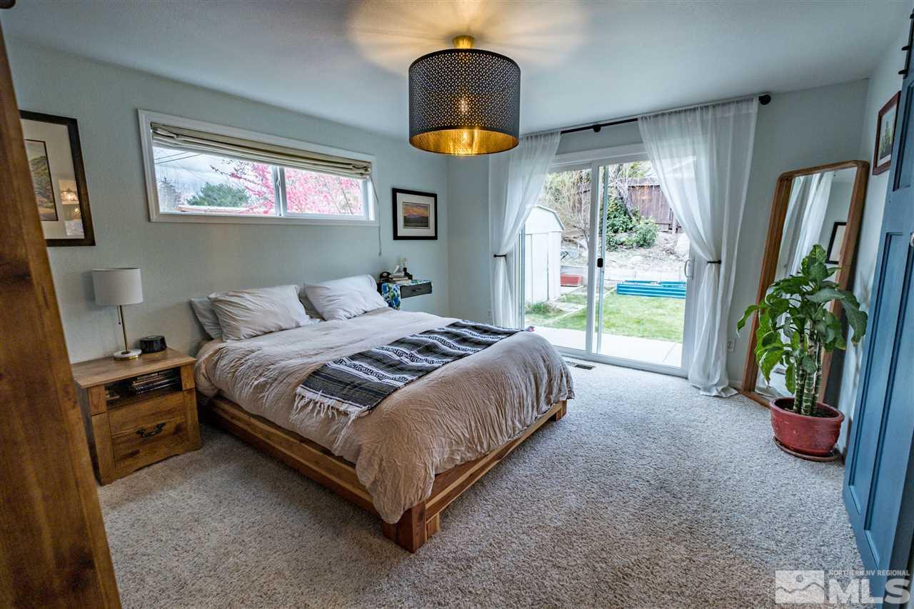 2250 Balsam Street Reno, NV 89509 - Photo 8 of 22 a spacious bedroom with a bed and a potted plant