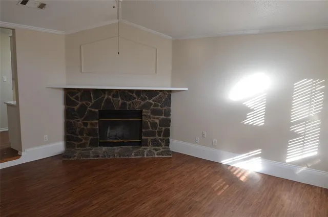 a room with a fireplace and wooden floor