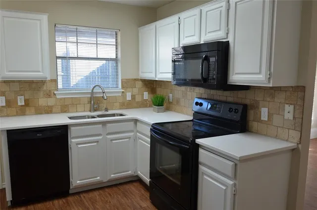 a kitchen with stainless steel appliances granite countertop a sink stove and microwave