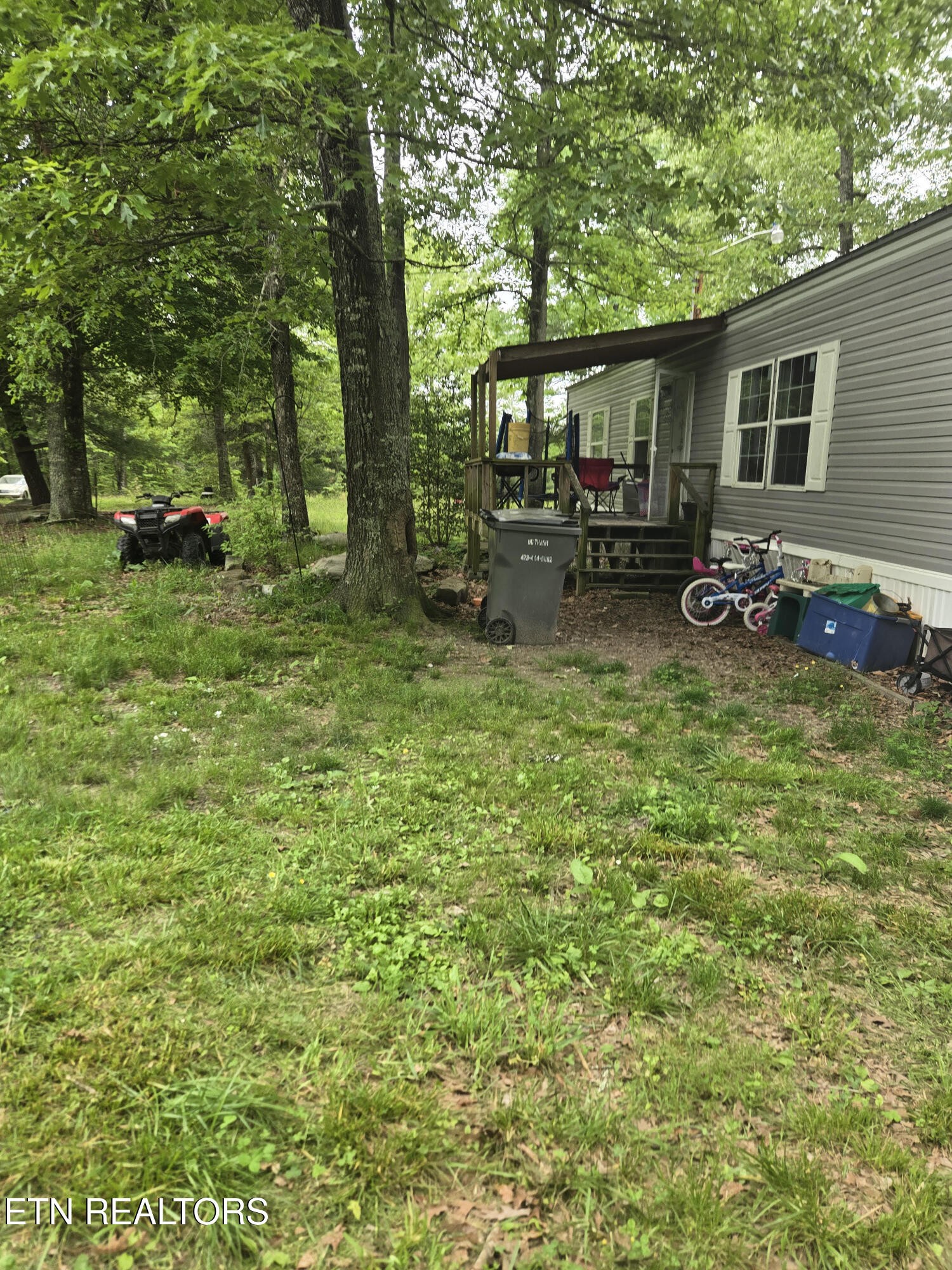 a view of swimming pool with lawn chairs and a big yard