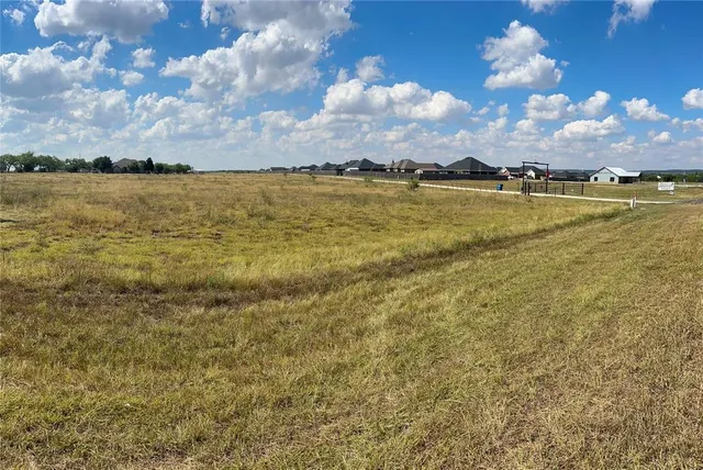 a view of a lake with houses in the background