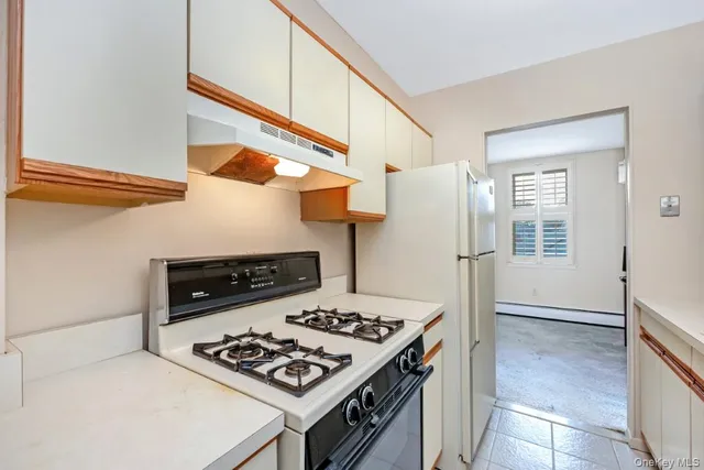 a white stove top oven sitting inside of a kitchen