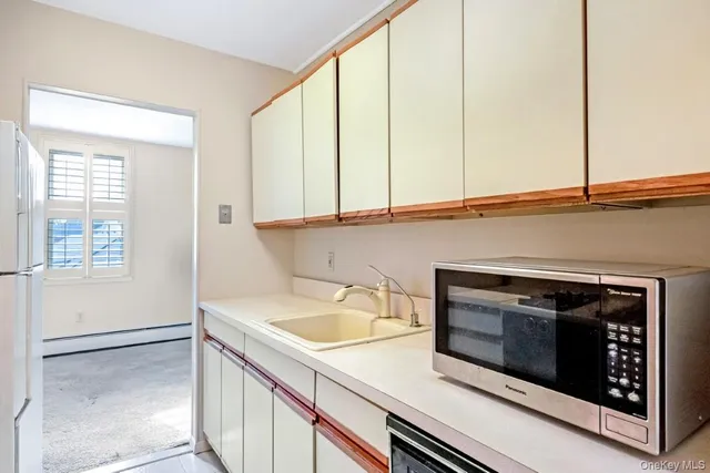 a kitchen with a sink and cabinets