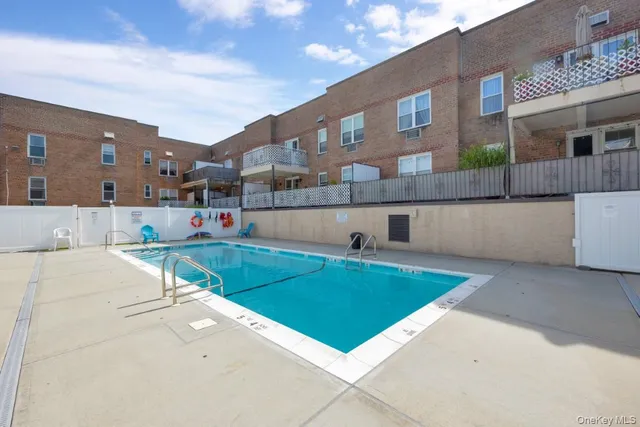 a view of a house with a backyard and a tub