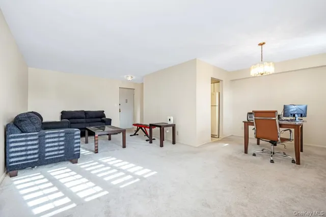 a living room with furniture and a lamp