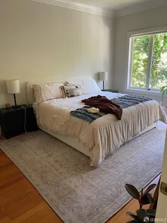 a bedroom with a bed and a night stand