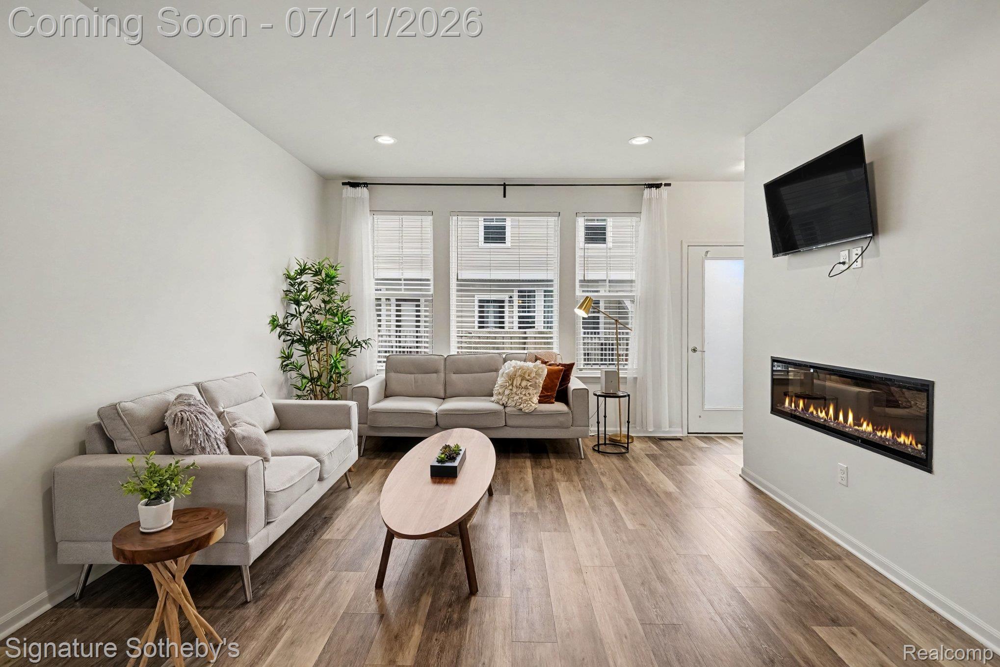 2500 Normandy Road, Unit 40 Royal Oak, MI 48073 - Photo 7 of 26 Living space featuring wood-finish flooring, recessed lighting, white walls, and a wall-mounted linear fireplace