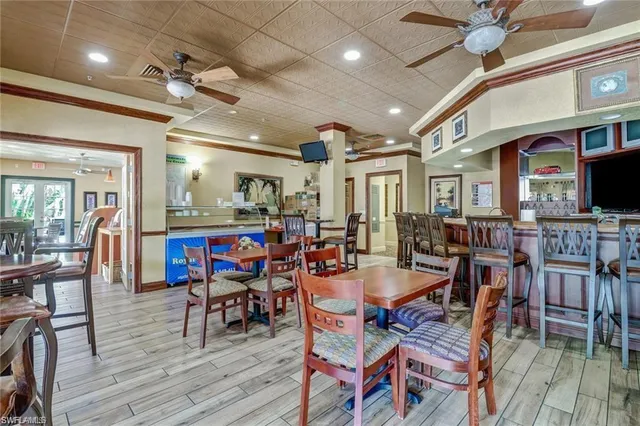 a view of a dining room with furniture wooden floor and chandelier