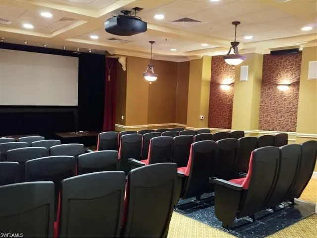 a media room with lots of chairs and a projector screen