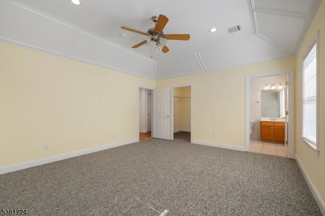 a view of a livingroom with a ceiling fan and window
