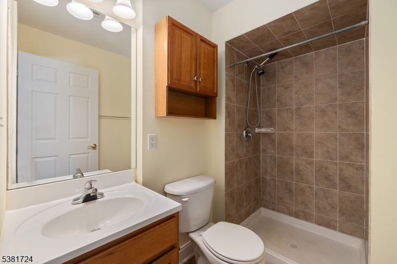 737 Jerusalem Road, Unit 2 Scotch Plains, NJ 07076 - Photo 27 of 32 a bathroom with a sink toilet and shower