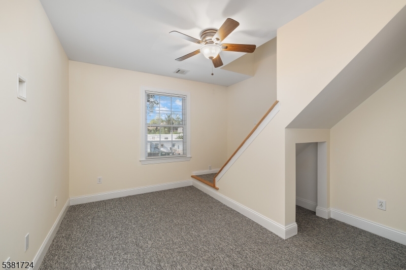 737 Jerusalem Road, Unit 2 Scotch Plains, NJ 07076 - Photo 28 of 32 an empty room with ceiling fan and window