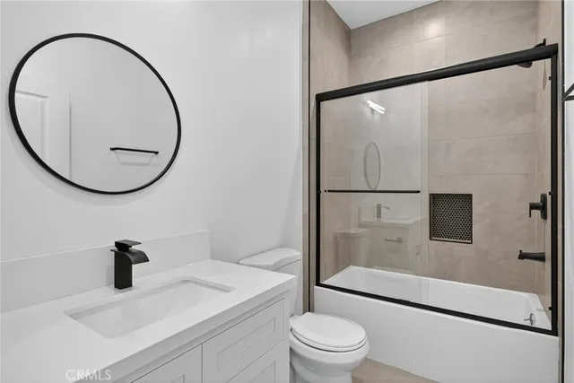 an empty room with a window and wooden floor