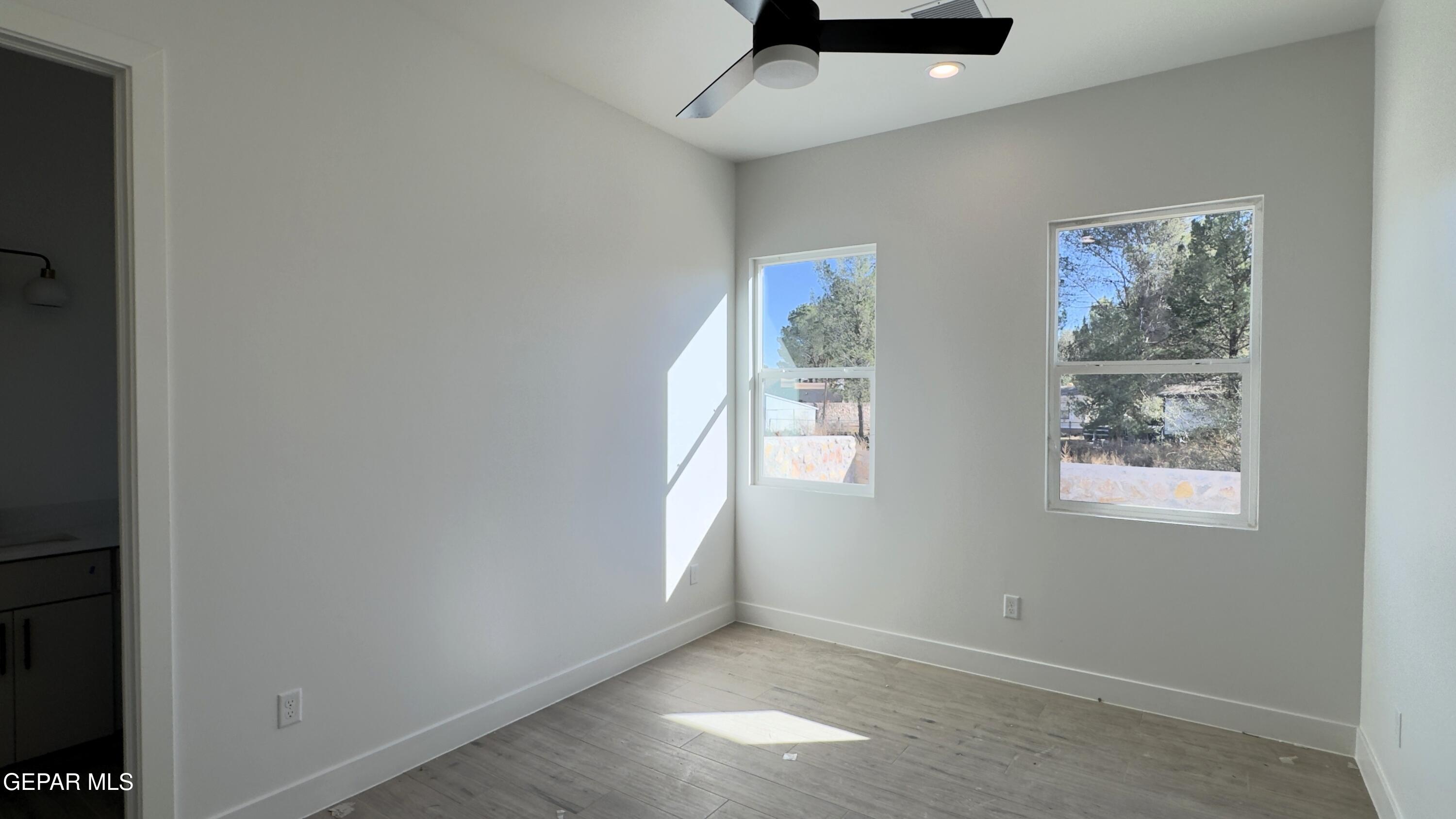 5656 Rio Bonito Circle El Paso, TX 79932 - Photo 12 of 36 an empty room with windows and closet