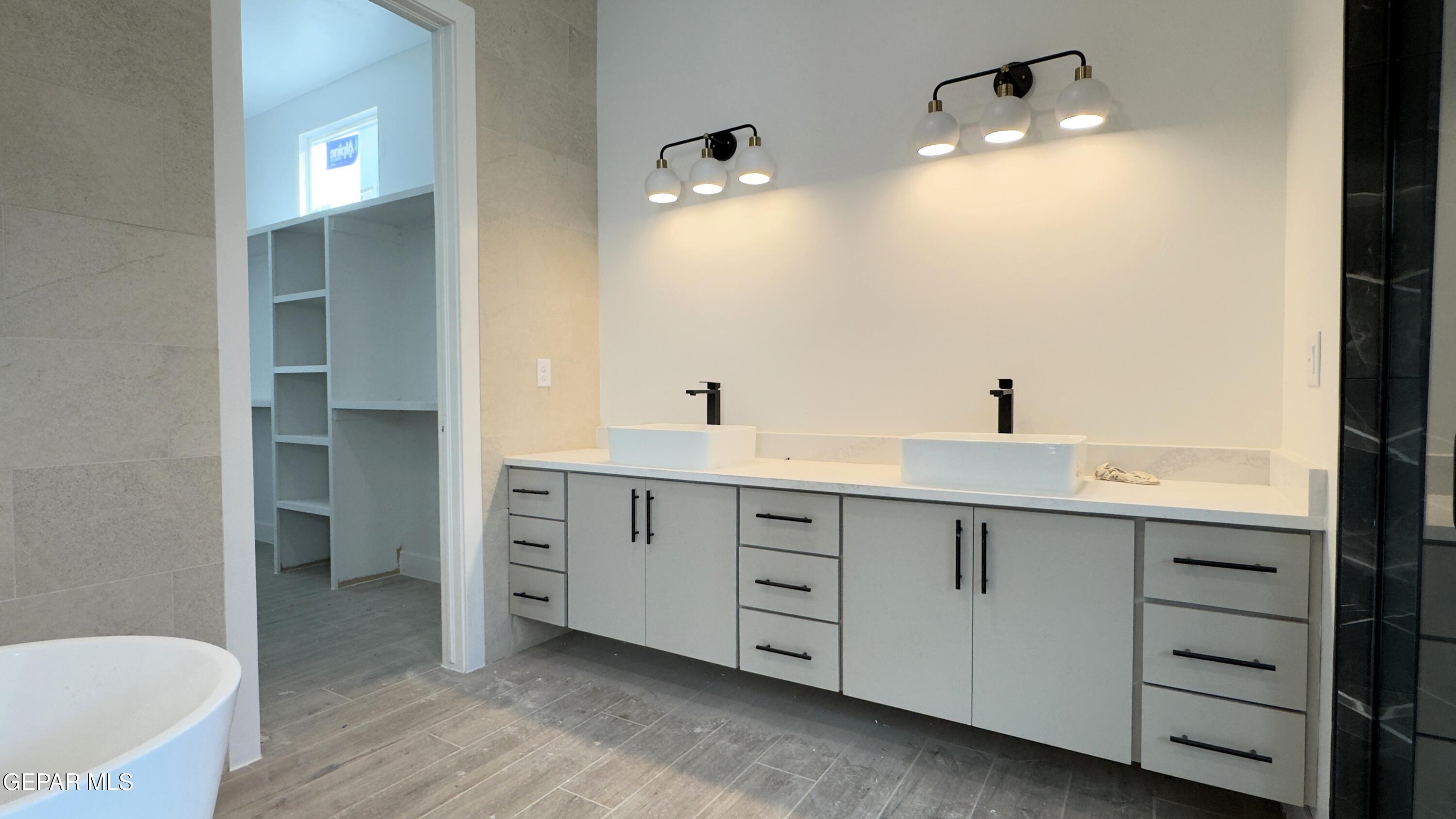 5656 Rio Bonito Circle El Paso, TX 79932 - Photo 21 of 36 a bathroom with a double vanity sink and a mirror