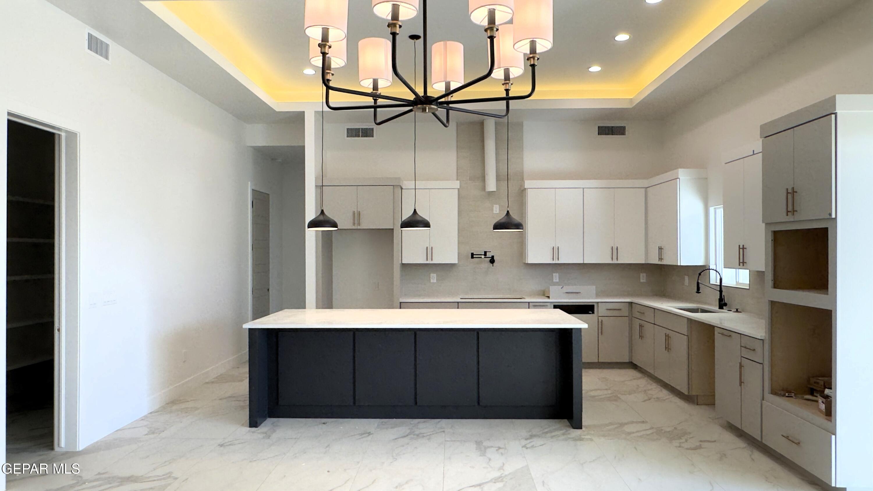 5656 Rio Bonito Circle El Paso, TX 79932 - Photo 6 of 36 a kitchen with a sink cabinets and appliances