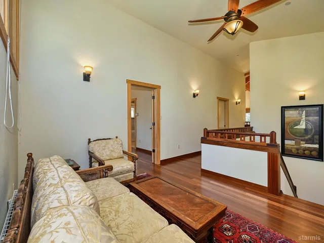 a living room with a couch and a wooden floor