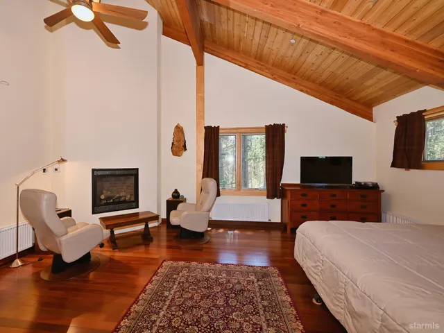 a bed room with furniture and a flat screen tv