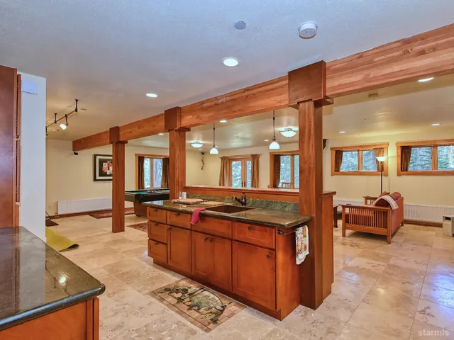 a room with pool table and windows