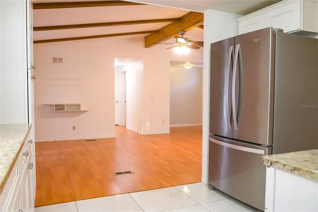 a view of a kitchen with a refrigerator and a sink