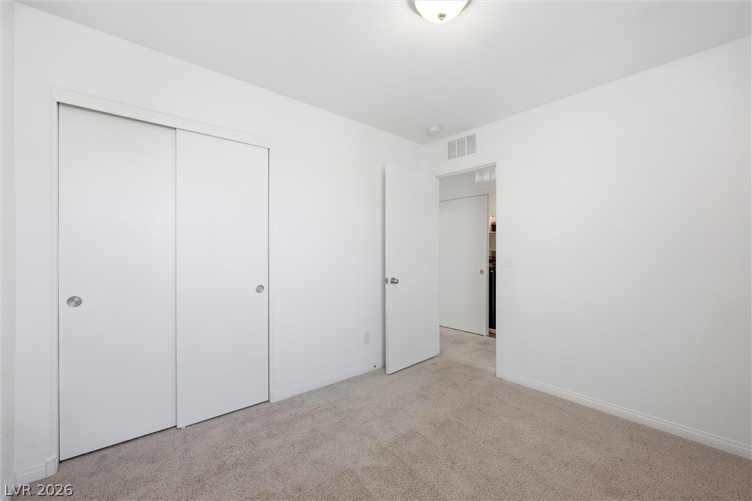 1811 Lincoln Road Las Vegas, NV 89115 - Photo 22 of 30 Unfurnished bedroom featuring light colored carpet and a closet