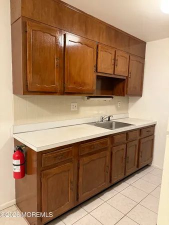 a kitchen with stainless steel appliances granite countertop a sink and a microwave