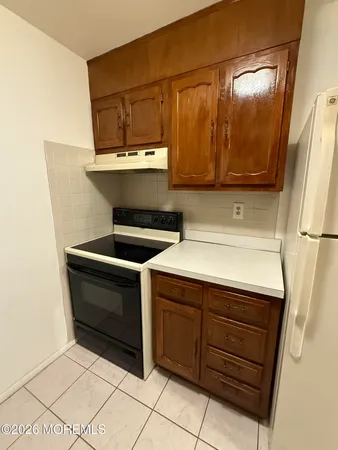 a kitchen with a sink and a refrigerator