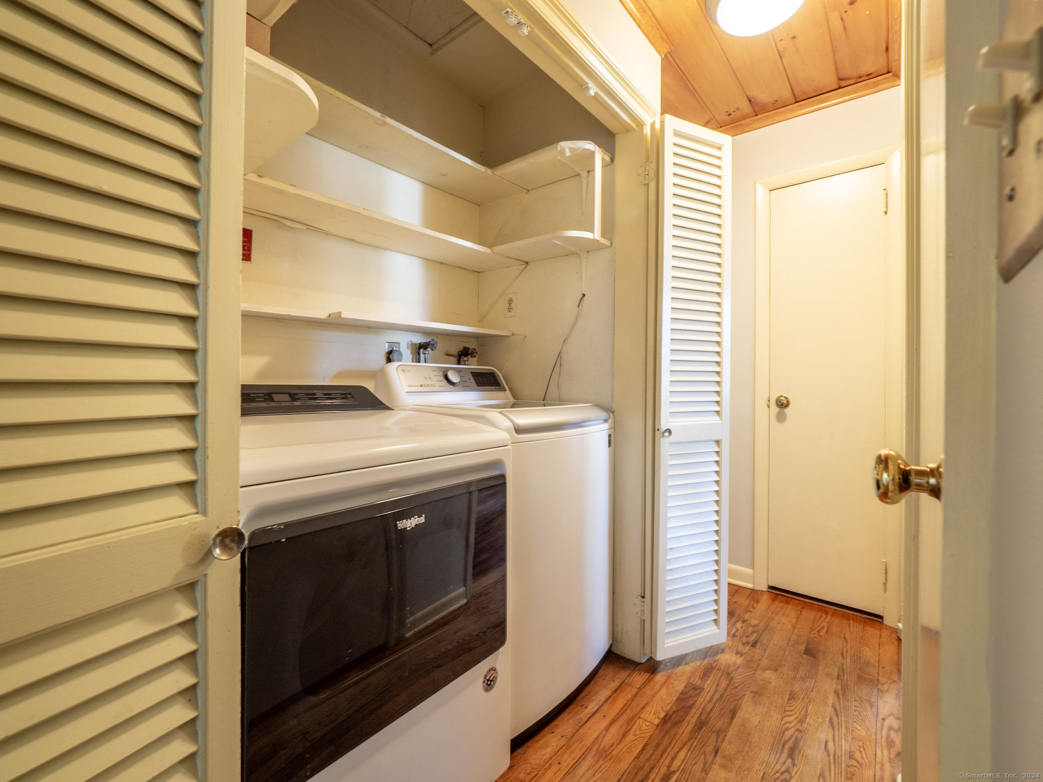 27 Woodland Way Ridgefield, CT 06877 - Photo 13 of 18 a view of washer and dryer with wooden floor