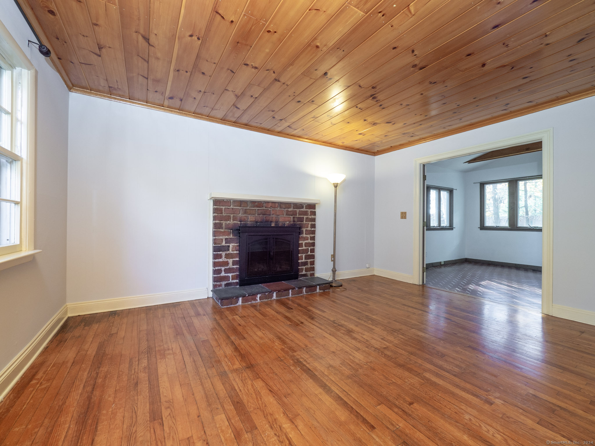27 Woodland Way Ridgefield, CT 06877 - Photo 3 of 18 a view of an empty room with wooden floor and a window