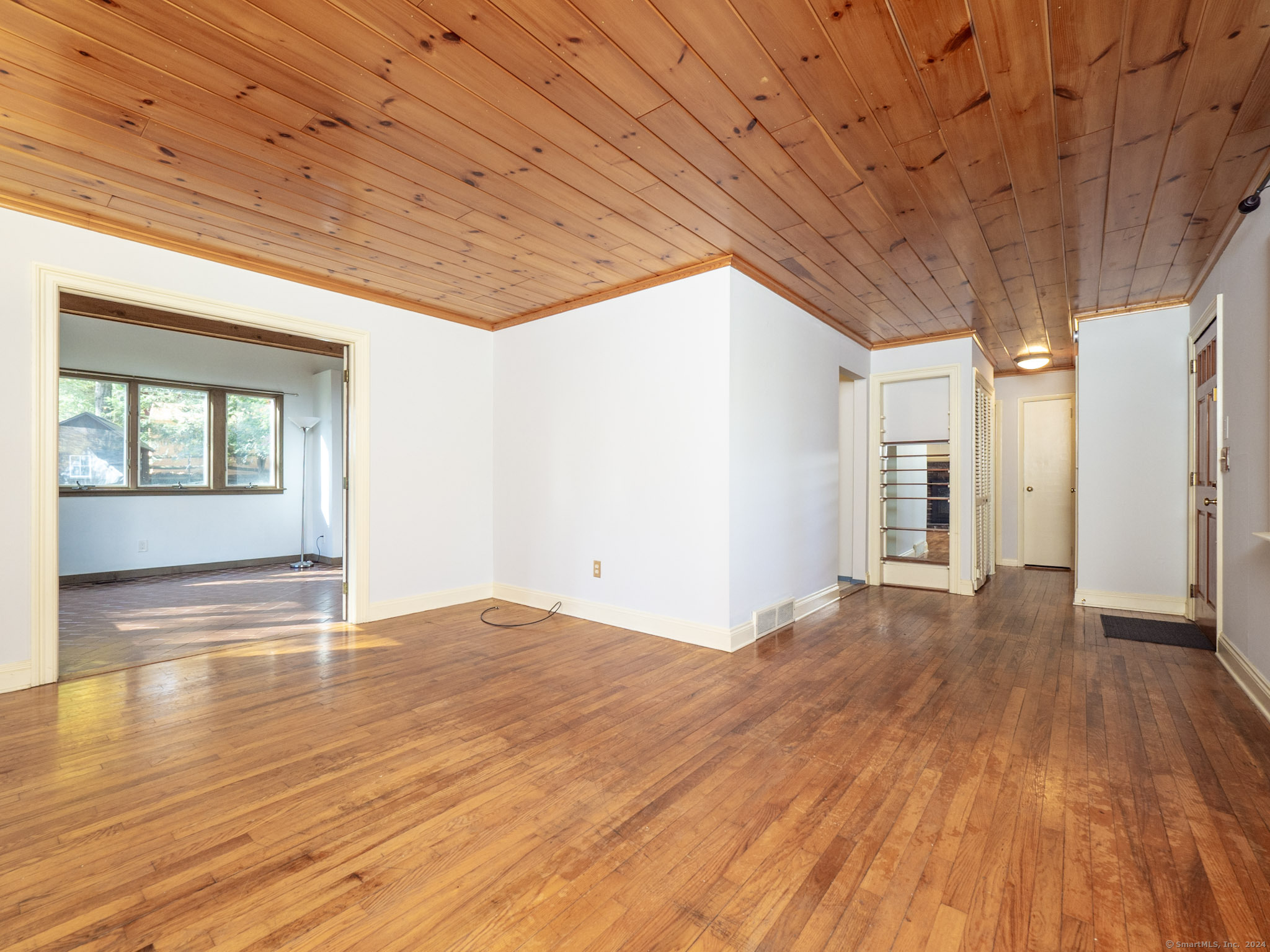 27 Woodland Way Ridgefield, CT 06877 - Photo 4 of 18 a view of empty room with wooden floor and fan
