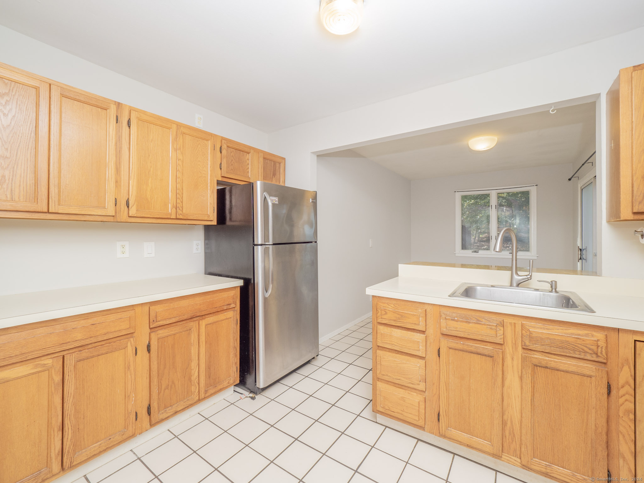 27 Woodland Way Ridgefield, CT 06877 - Photo 9 of 18 a kitchen with white cabinets and refrigerator