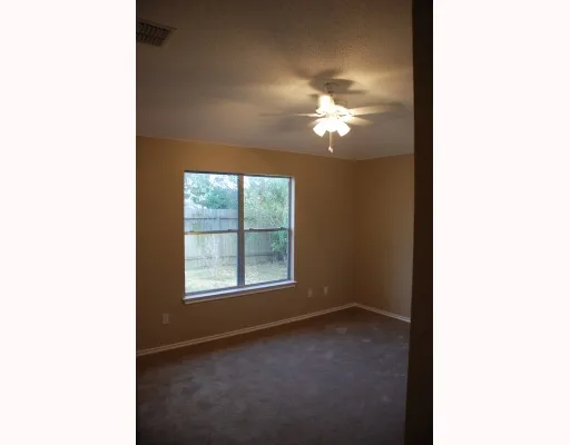 a view of a livingroom with a ceiling fan and window