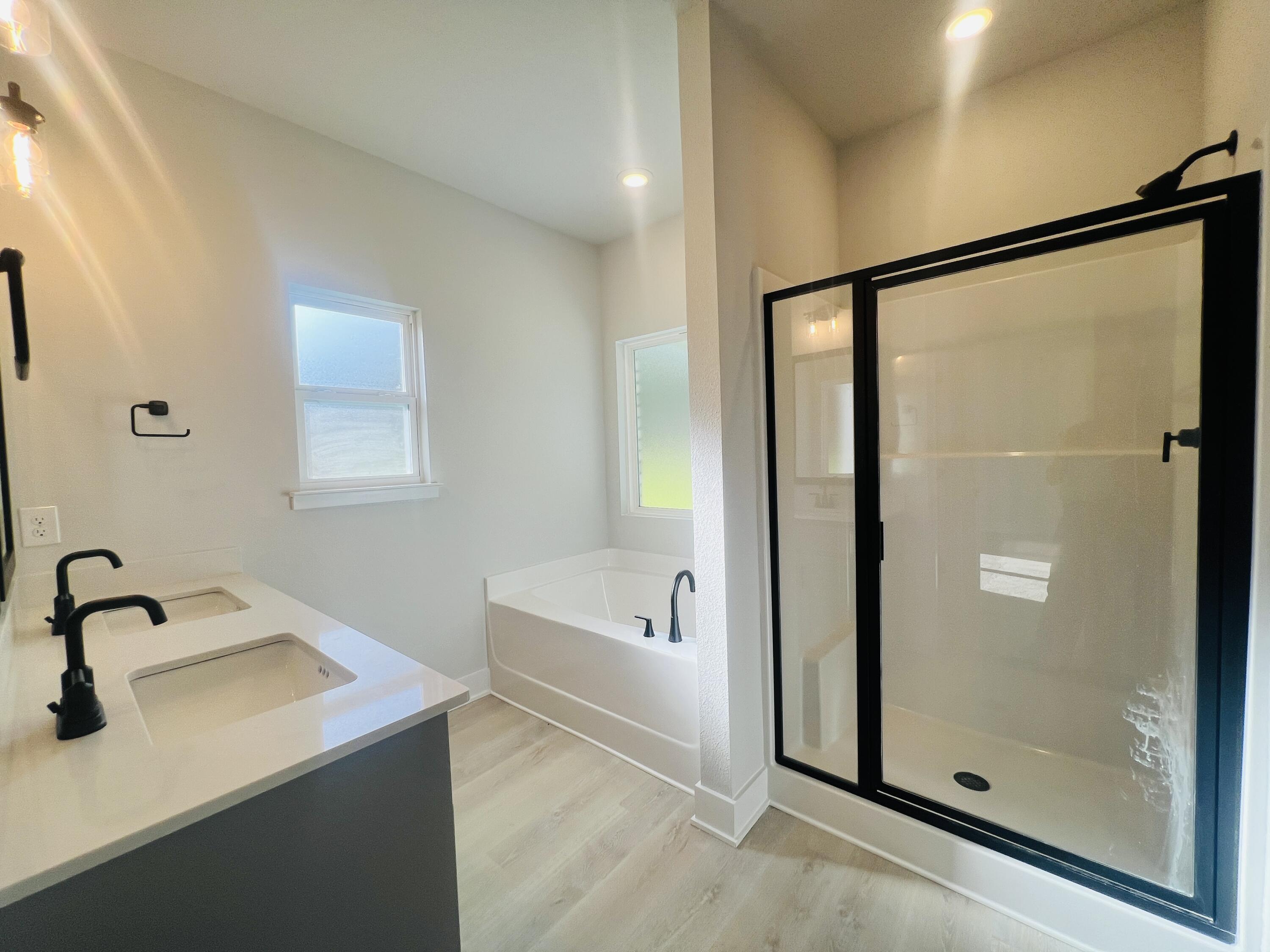 5303 Hidden Pines Circle Milton, FL 32583 - Photo 12 of 22 a bathroom with a bathtub and a shower