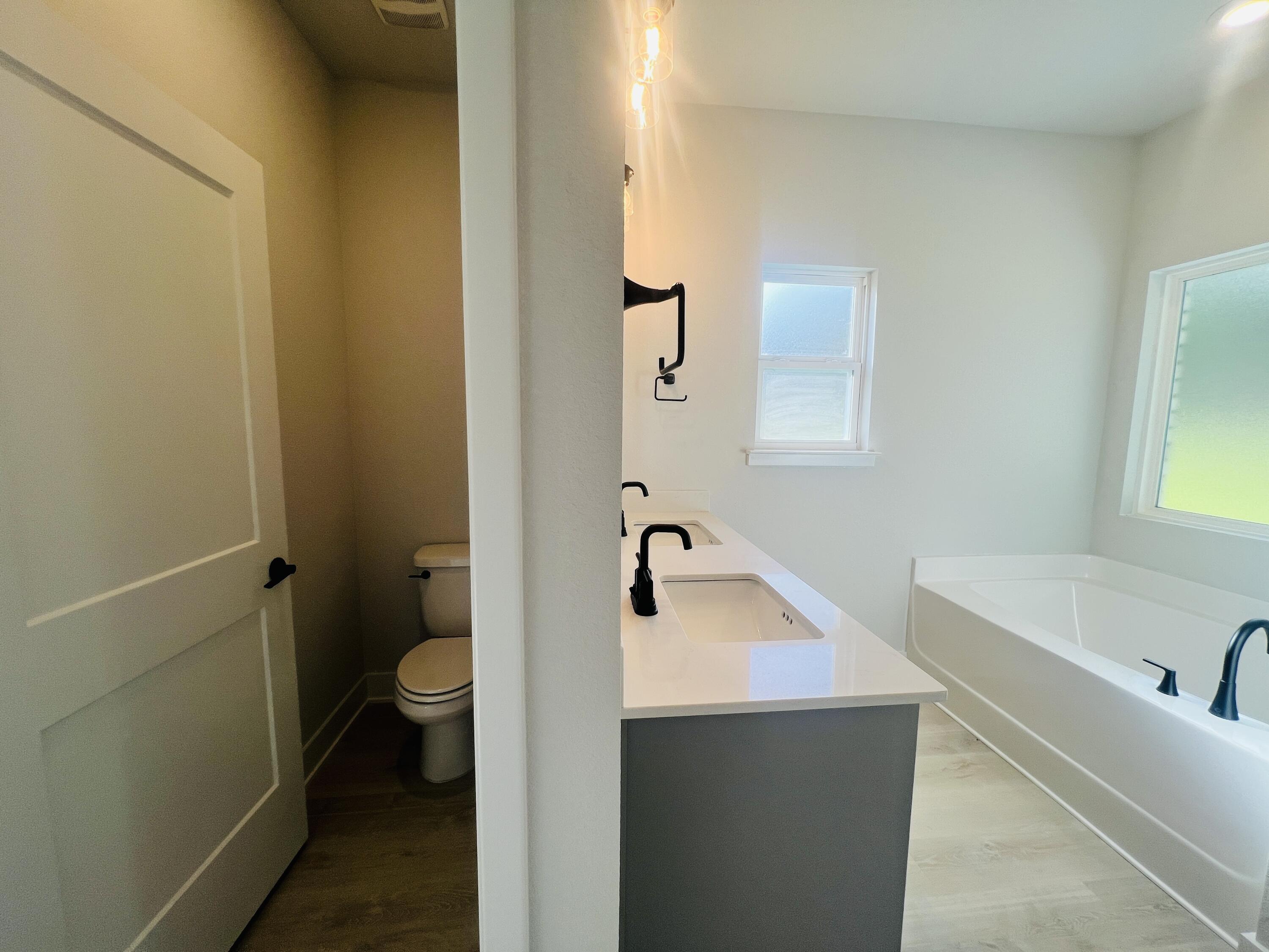 5303 Hidden Pines Circle Milton, FL 32583 - Photo 13 of 22 a bathroom with a sink and mirror with toilet