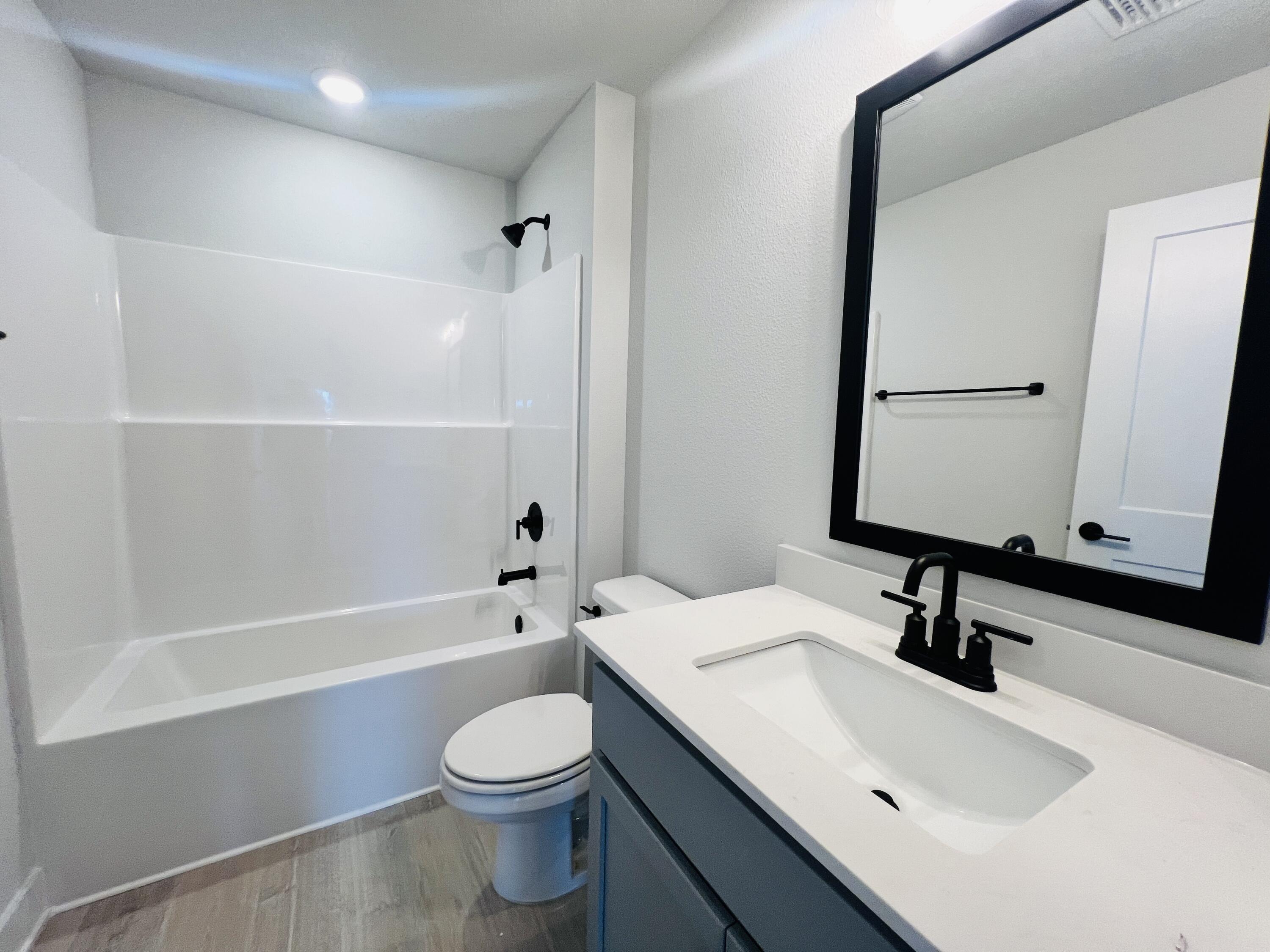 5303 Hidden Pines Circle Milton, FL 32583 - Photo 17 of 22 a bathroom with a sink a toilet and a bathtub